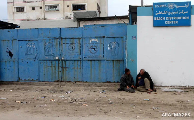 Palestinians take part in a protest in front of the UNRWA headquarters, against reducing the services provided to Palestine refugees in Gaza city, on Feb. 26, 2012. Photo by Ashraf Amra