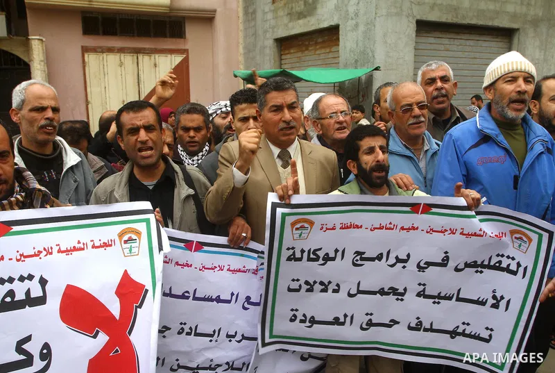 Palestinians take part in a protest in front of the UNRWA headquarters, against reducing the services provided to Palestine refugees in Gaza city, on Feb. 26, 2012. Photo by Ashraf Amra
