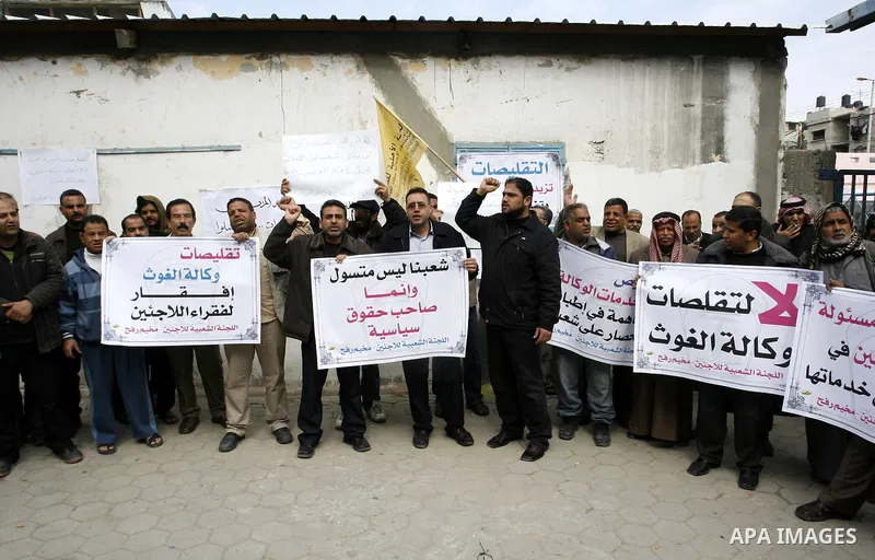 Palestinians take part during a protest against the suspension of aid provided to them from the Agency Relief and Works Agency (UNRWA) during a protest in front of one of the centers of the distribution of aid to UNRWA i...