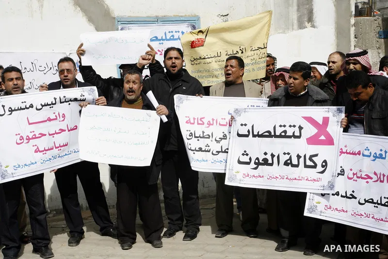 Palestinians take part during a protest against the suspension of aid provided to them from the Agency Relief and Works Agency (UNRWA) during a protest in front of one of the centers of the distribution of aid to UNRWA i...