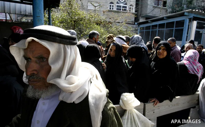 Palestinians receive their monthly food aid at a UN distribution center in the Rafah refugee camp, southern Gaza Strip on February 26, 2012. Photo by Abed Rahim Khatib