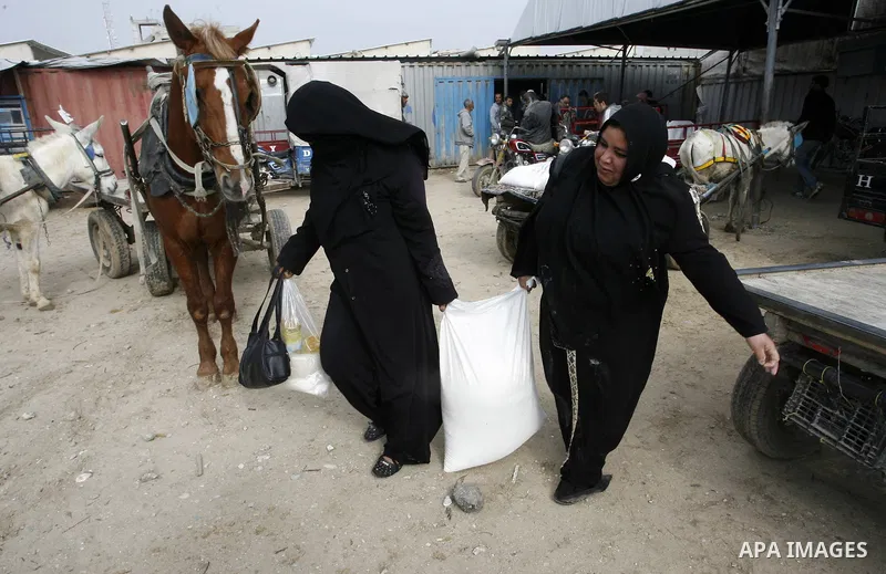 Palestinians receive their monthly food aid at a UN distribution center in the Rafah refugee camp, southern Gaza Strip on February 26, 2012. Photo by Abed Rahim Khatib