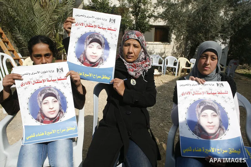 Relatives of Palestinian detainee, Hana Shalabi, holds placards depicting Shalabi, in the West Bank village of Birqin, near Jenin February 27, 2012. Shalabi, released by Israel in a prisoner swap last year but re-arreste...