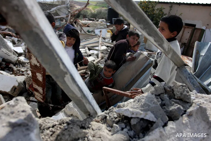Palestinian Children inspects their hous which was demolished by Israeli army that was built without a construction permit, in bedouin area, village of Jaba, north of Jerusalem on Feb. 27, 2012. Photo by Issam Rimawi