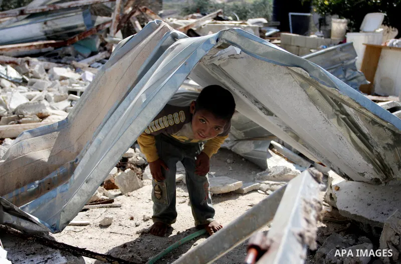 Palestinian Children inspects their hous which was demolished by Israeli army that was built without a construction permit, in bedouin area, village of Jaba, north of Jerusalem on Feb. 27, 2012. Photo by Issam Rimawi