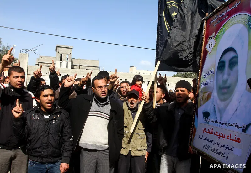 Palestinian Protestors hold a picture of Palestinian prisoner Hana'a Shalabi during a protest outside the United Nations building in Gaza City on February 28, 2012. Shalabi, released by Israel in a prisoner swap last yea...
