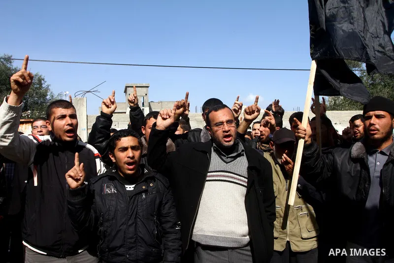 Palestinian Protestors hold a picture of Palestinian prisoner Hana'a Shalabi during a protest outside the United Nations building in Gaza City on February 28, 2012. Shalabi, released by Israel in a prisoner swap last yea...