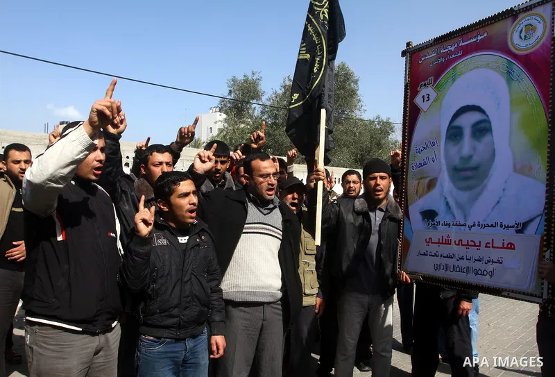 Palestinian Protestors hold a picture of Palestinian prisoner Hana'a Shalabi during a protest outside the United Nations building in Gaza City on February 28, 2012. Shalabi, released by Israel in a prisoner swap last yea...