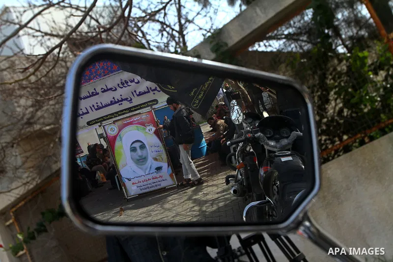 A picture of Palestinian prisoner Hana'a Shalabi stands outside a protest tent outside the United Nations building in Gaza City on February 28, 2012. Shalabi, released by Israel in a prisoner swap last year but re-arrest...