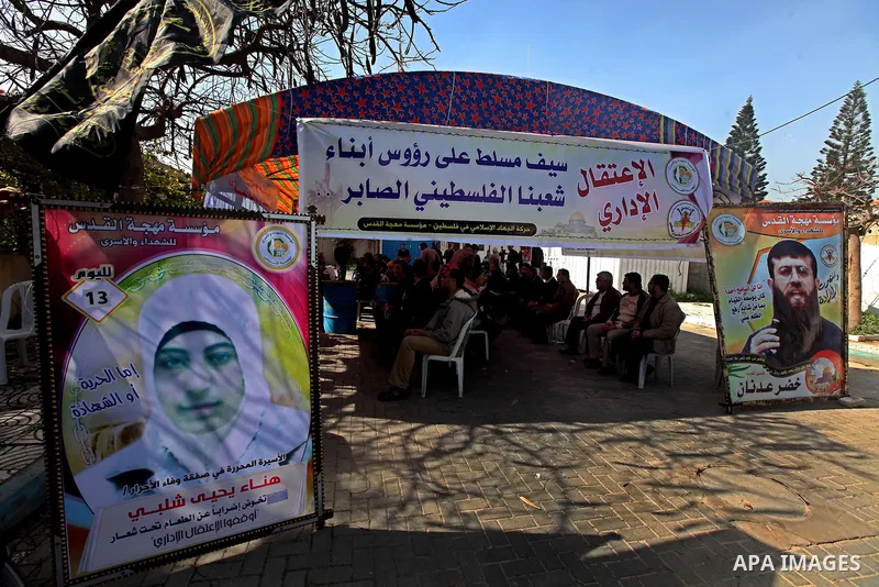 A picture of Palestinian prisoner Hana'a Shalabi stands outside a protest tent outside the United Nations building in Gaza City on February 28, 2012. Shalabi, released by Israel in a prisoner swap last year but re-arrest...