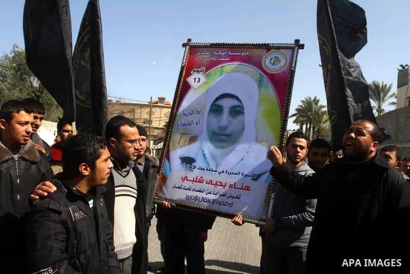 Palestinian Protestors hold a picture of Palestinian prisoner Hana'a Shalabi during a protest outside the United Nations building in Gaza City on February 28, 2012. Shalabi, released by Israel in a prisoner swap last yea...