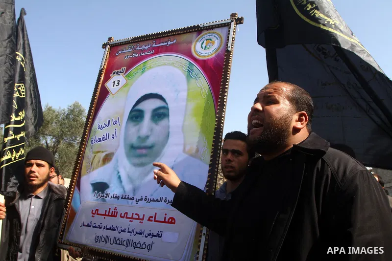 Palestinian Protestors hold a picture of Palestinian prisoner Hana'a Shalabi during a protest outside the United Nations building in Gaza City on February 28, 2012. Shalabi, released by Israel in a prisoner swap last yea...