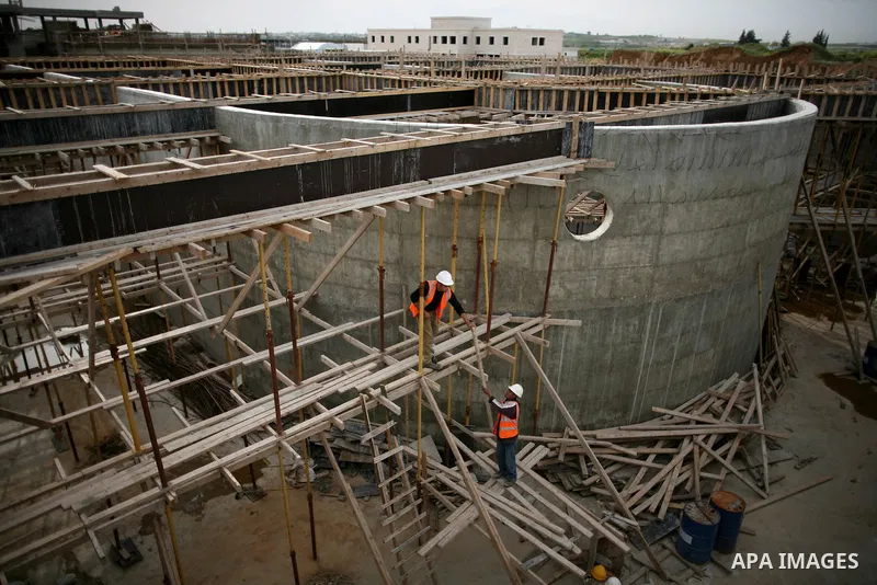 Palestinian workers work in building a sewage desalination station in the Northern Gaza Strip on Feb. 26, 2012. The Sewage desalination project is funded by the International Bank and EU with budget 40 million dollar. Th...