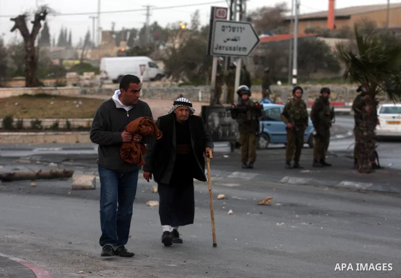 An Israeli soldier fires tear gas during clashes with stone-throwing Palestinians in the West Bank district of al-Ram, bordering Israel and annexed East Jerusalem, on February 28, 2012. Photo by Issam Rimawi