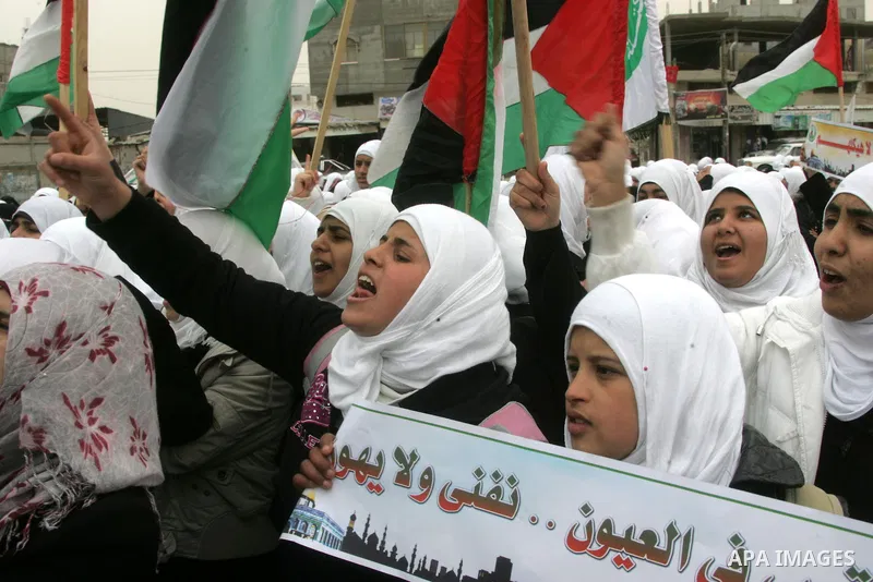 Palestinians female students shout slogans as she and others take part in a protest organized by the Islamic Hamas movement in the Rafah, southern Gaza Strip, on February 29, 2012, to show solidarity with Palestinians pr...