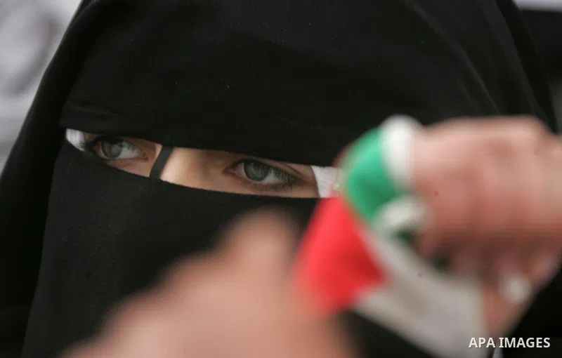 Palestinians female students shout slogans as she and others take part in a protest organized by the Islamic Hamas movement in the Rafah, southern Gaza Strip, on February 29, 2012, to show solidarity with Palestinians pr...