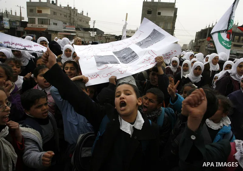 Palestinians female students shout slogans as she and others take part in a protest organized by the Islamic Hamas movement in the Rafah, southern Gaza Strip, on February 29, 2012, to show solidarity with Palestinians pr...
