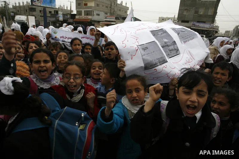 Palestinians female students shout slogans as she and others take part in a protest organized by the Islamic Hamas movement in the Rafah, southern Gaza Strip, on February 29, 2012, to show solidarity with Palestinians pr...