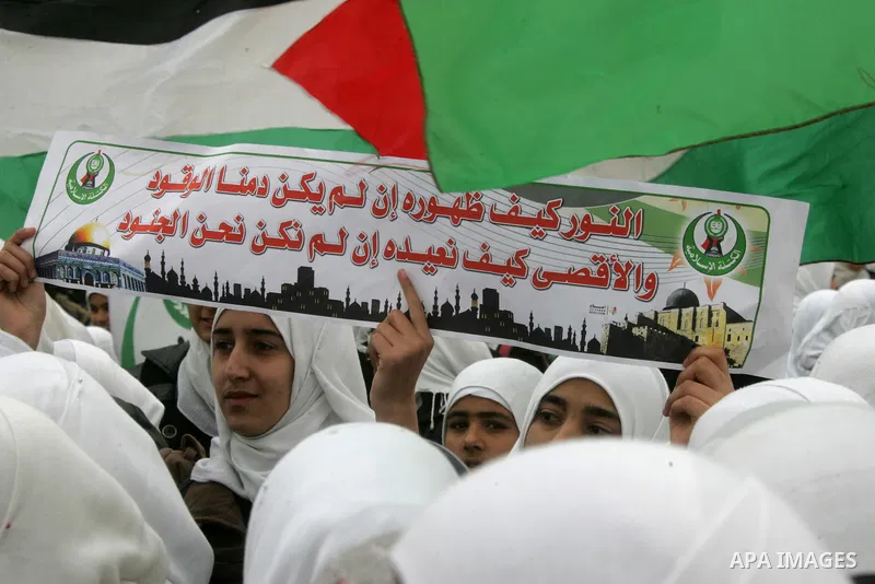 Palestinians female students shout slogans as she and others take part in a protest organized by the Islamic Hamas movement in the Rafah, southern Gaza Strip, on February 29, 2012, to show solidarity with Palestinians pr...