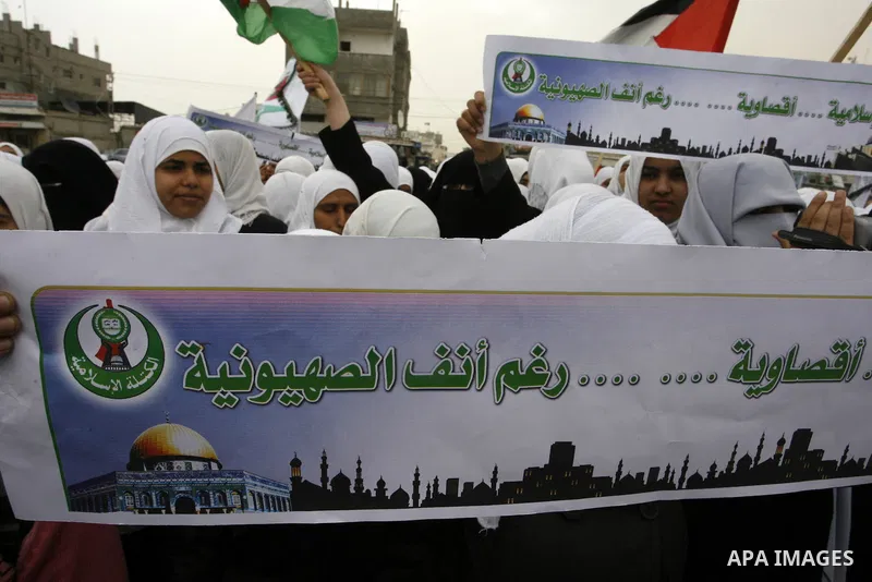 Palestinians female students shout slogans as she and others take part in a protest organized by the Islamic Hamas movement in the Rafah, southern Gaza Strip, on February 29, 2012, to show solidarity with Palestinians pr...