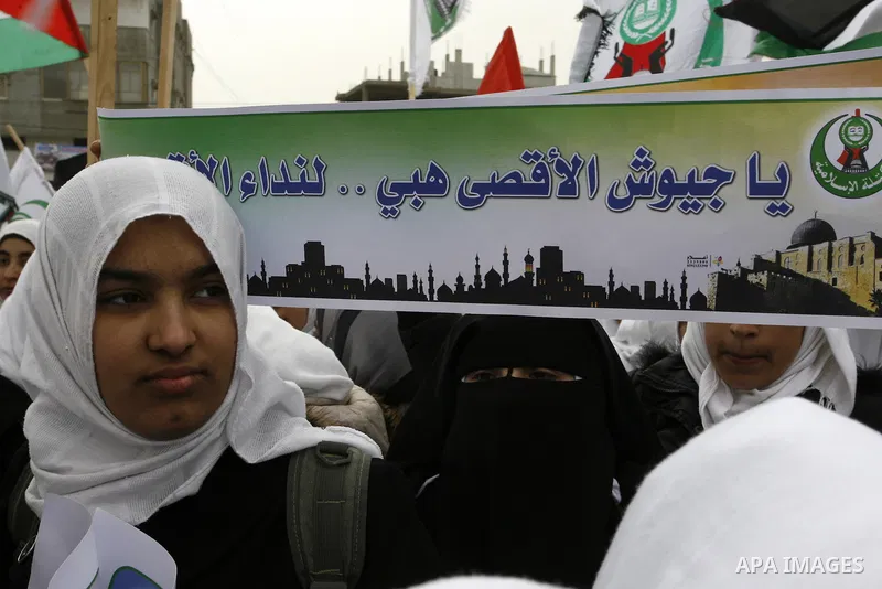 Palestinians female students shout slogans as she and others take part in a protest organized by the Islamic Hamas movement in the Rafah, southern Gaza Strip, on February 29, 2012, to show solidarity with Palestinians pr...