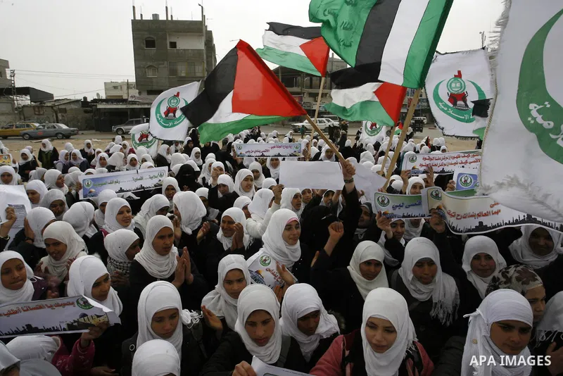 Palestinians female students shout slogans as she and others take part in a protest organized by the Islamic Hamas movement in the Rafah, southern Gaza Strip, on February 29, 2012, to show solidarity with Palestinians pr...
