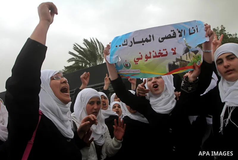Palestinians female students shout slogans as she and others take part in a protest organized by the Islamic Hamas movement in Gaza city, on February 29, 2012, to show solidarity with Palestinians protesting last week at...
