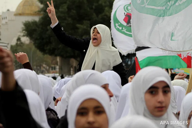 Palestinians female students shout slogans as she and others take part in a protest organized by the Islamic Hamas movement in Gaza city, on February 29, 2012, to show solidarity with Palestinians protesting last week at...