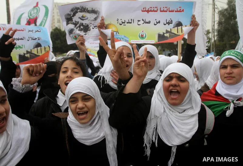 Palestinians female students shout slogans as she and others take part in a protest organized by the Islamic Hamas movement in Gaza city, on February 29, 2012, to show solidarity with Palestinians protesting last week at...