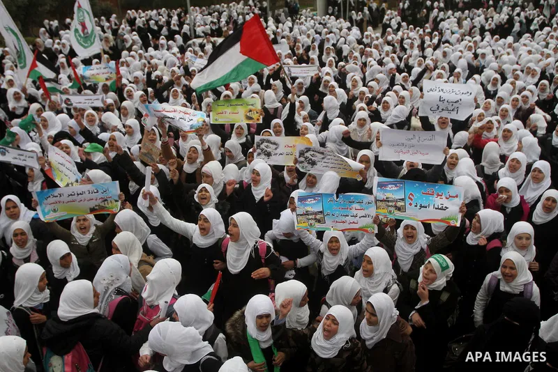 Palestinians female students shout slogans as she and others take part in a protest organized by the Islamic Hamas movement in Gaza city, on February 29, 2012, to show solidarity with Palestinians protesting last week at...