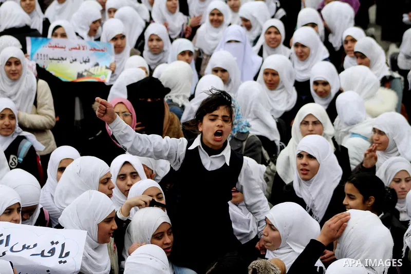Palestinians female students shout slogans as she and others take part in a protest organized by the Islamic Hamas movement in Gaza city, on February 29, 2012, to show solidarity with Palestinians protesting last week at...