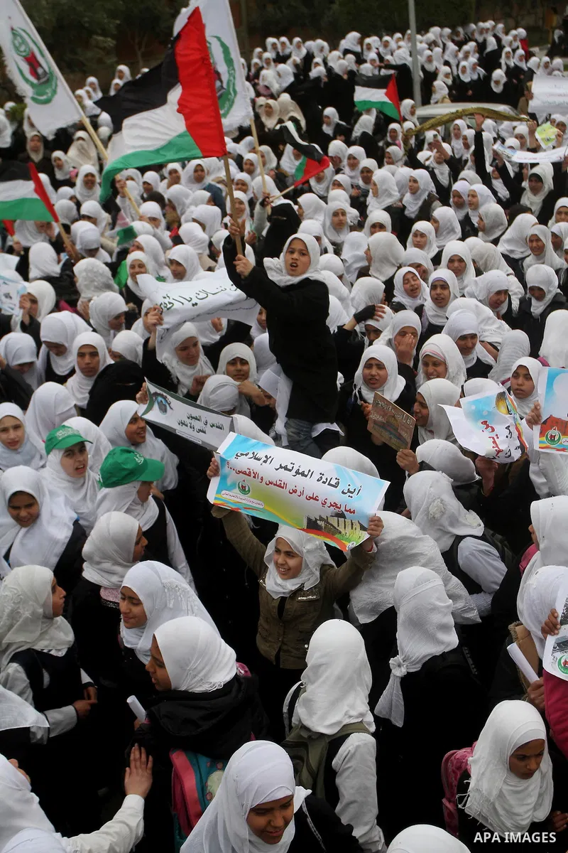 Palestinians female students shout slogans as she and others take part in a protest organized by the Islamic Hamas movement in Gaza city, on February 29, 2012, to show solidarity with Palestinians protesting last week at...
