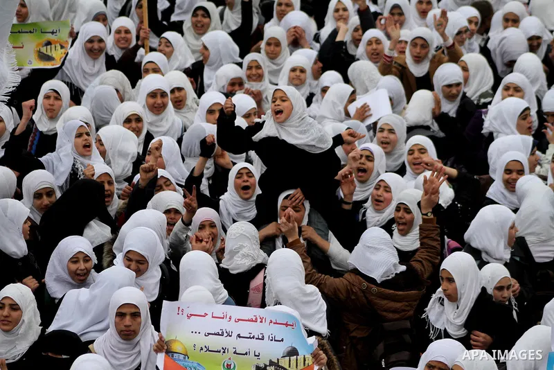 Palestinians female students shout slogans as she and others take part in a protest organized by the Islamic Hamas movement in Gaza city, on February 29, 2012, to show solidarity with Palestinians protesting last week at...
