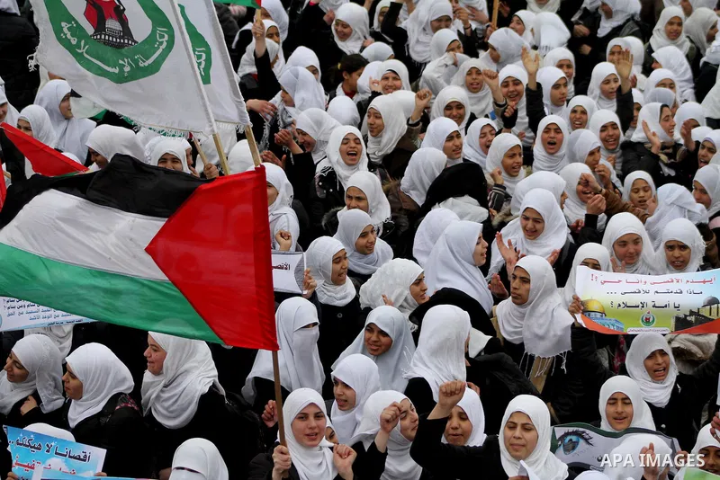 Palestinians female students shout slogans as she and others take part in a protest organized by the Islamic Hamas movement in Gaza city, on February 29, 2012, to show solidarity with Palestinians protesting last week at...