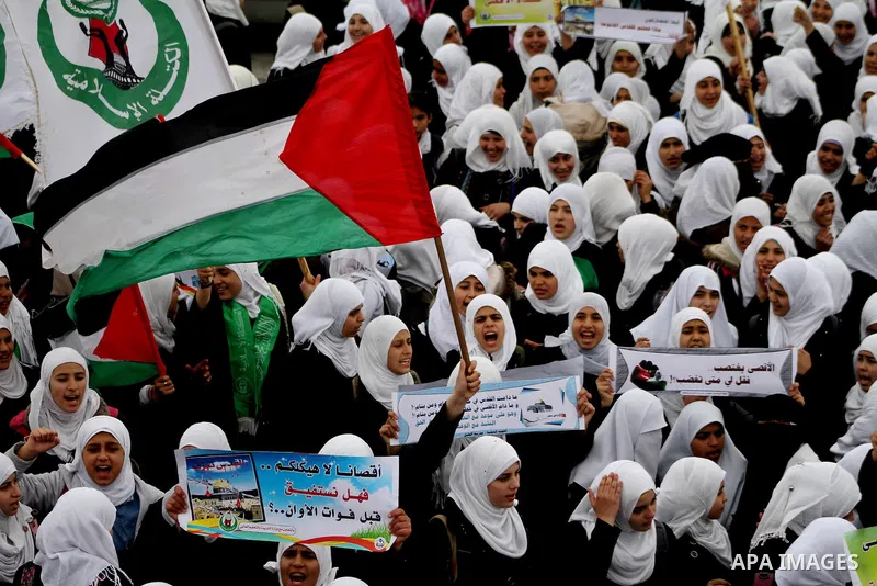 Palestinians female students shout slogans as she and others take part in a protest organized by the Islamic Hamas movement in Gaza city, on February 29, 2012, to show solidarity with Palestinians protesting last week at...