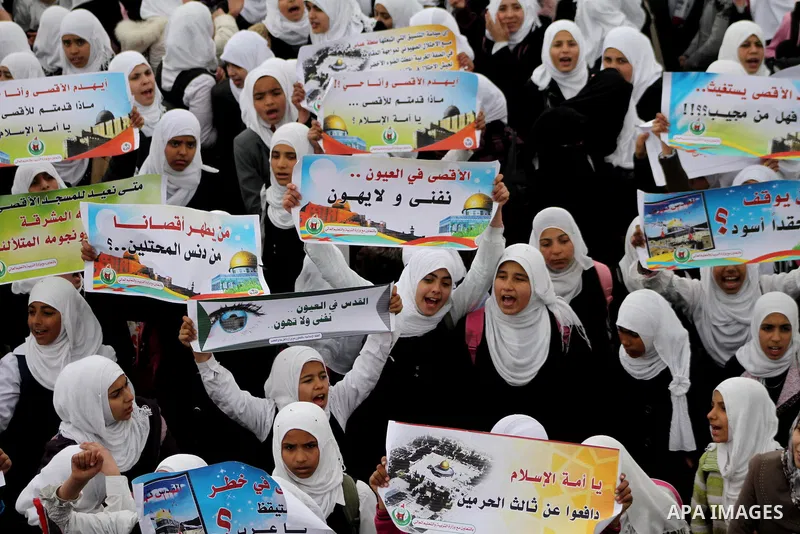 Palestinians female students shout slogans as she and others take part in a protest organized by the Islamic Hamas movement in Gaza city, on February 29, 2012, to show solidarity with Palestinians protesting last week at...