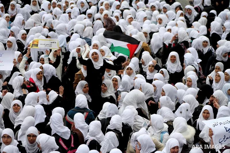 Palestinians female students shout slogans as she and others take part in a protest organized by the Islamic Hamas movement in Gaza city, on February 29, 2012, to show solidarity with Palestinians protesting last week at...