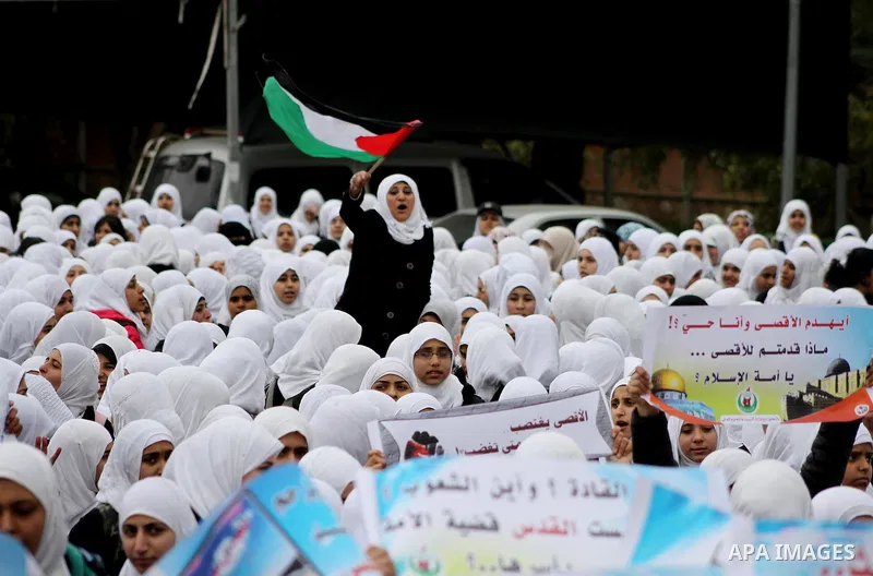 Palestinians female students shout slogans as she and others take part in a protest organized by the Islamic Hamas movement in Gaza city, on February 29, 2012, to show solidarity with Palestinians protesting last week at...