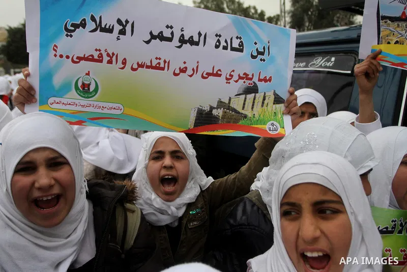 Palestinians female students shout slogans as she and others take part in a protest organized by the Islamic Hamas movement in Gaza city, on February 29, 2012, to show solidarity with Palestinians protesting last week at...