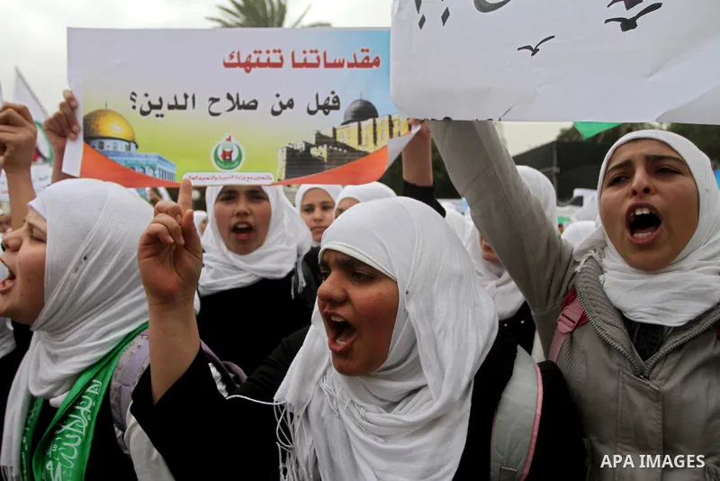Palestinians female students shout slogans as she and others take part in a protest organized by the Islamic Hamas movement in Gaza city, on February 29, 2012, to show solidarity with Palestinians protesting last week at...