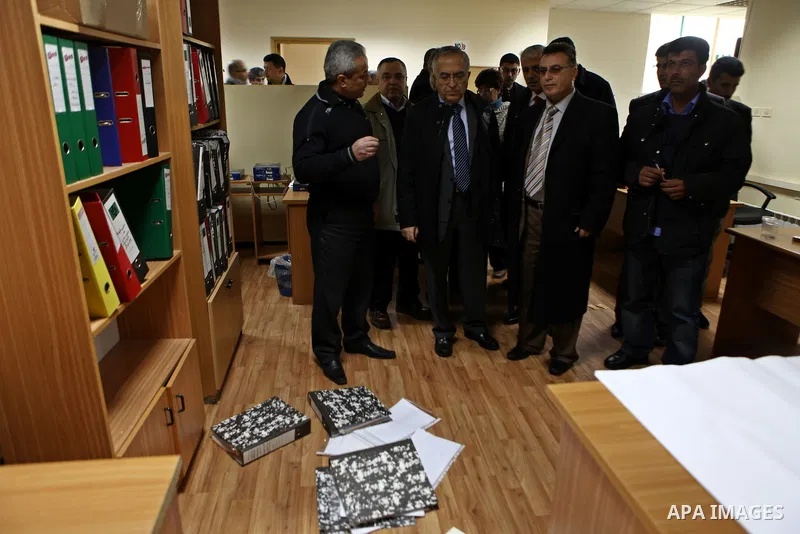 Palestinian Prime Minister Salam Fayyad, left, visits the offices of al-Watan TV after an Israeli army pre-dawn raid in the West Bank city of Ramallah, Wednesday, Feb. 29, 2012. A Palestinian broadcaster says Israeli tro...
