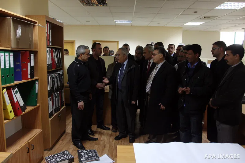 Palestinian Prime Minister Salam Fayyad, left, visits the offices of al-Watan TV after an Israeli army pre-dawn raid in the West Bank city of Ramallah, Wednesday, Feb. 29, 2012. A Palestinian broadcaster says Israeli tro...