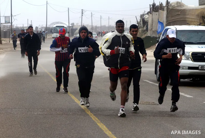 Participants compete in the UN-sponsored Gaza marathon in Gaza City on March 1, 2012. Thousands of runners braved temperatures hovering just above zero degrees centigrade to take part in the impoverished Palestinian terr...