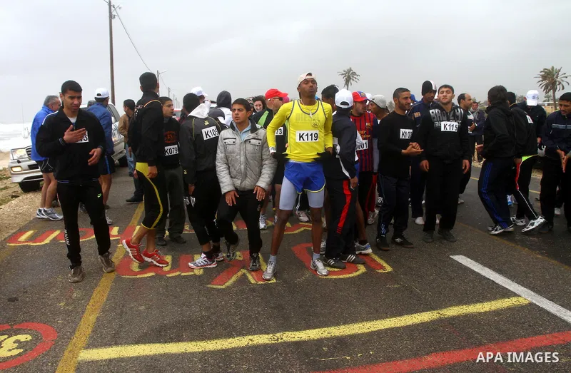 Participants compete in the UN-sponsored Gaza marathon in Gaza City on March 1, 2012. Thousands of runners braved temperatures hovering just above zero degrees centigrade to take part in the impoverished Palestinian terr...