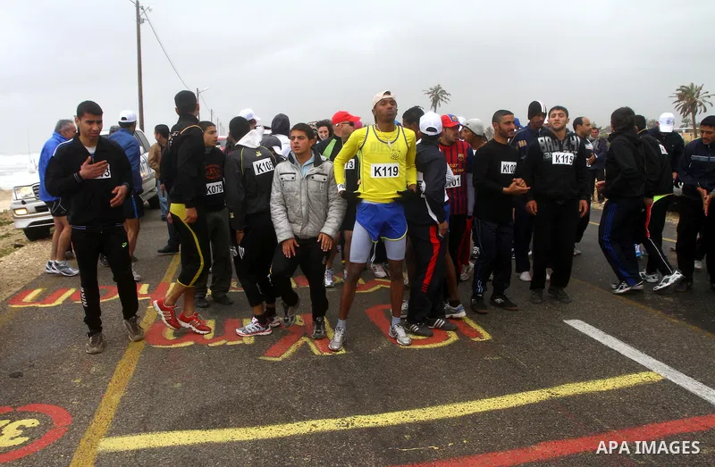 Participants compete in the UN-sponsored Gaza marathon in Gaza City on March 1, 2012. Thousands of runners braved temperatures hovering just above zero degrees centigrade to take part in the impoverished Palestinian terr...