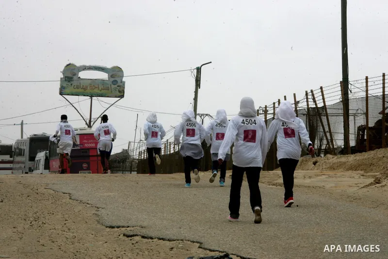 Participants warm up before competing in the UN-sponsored Gaza marathon in Rafah town, in the southern Gaza Strip on March 1, 2012. Thousands of runners braved temperatures hovering just above zero degrees centigrade to...