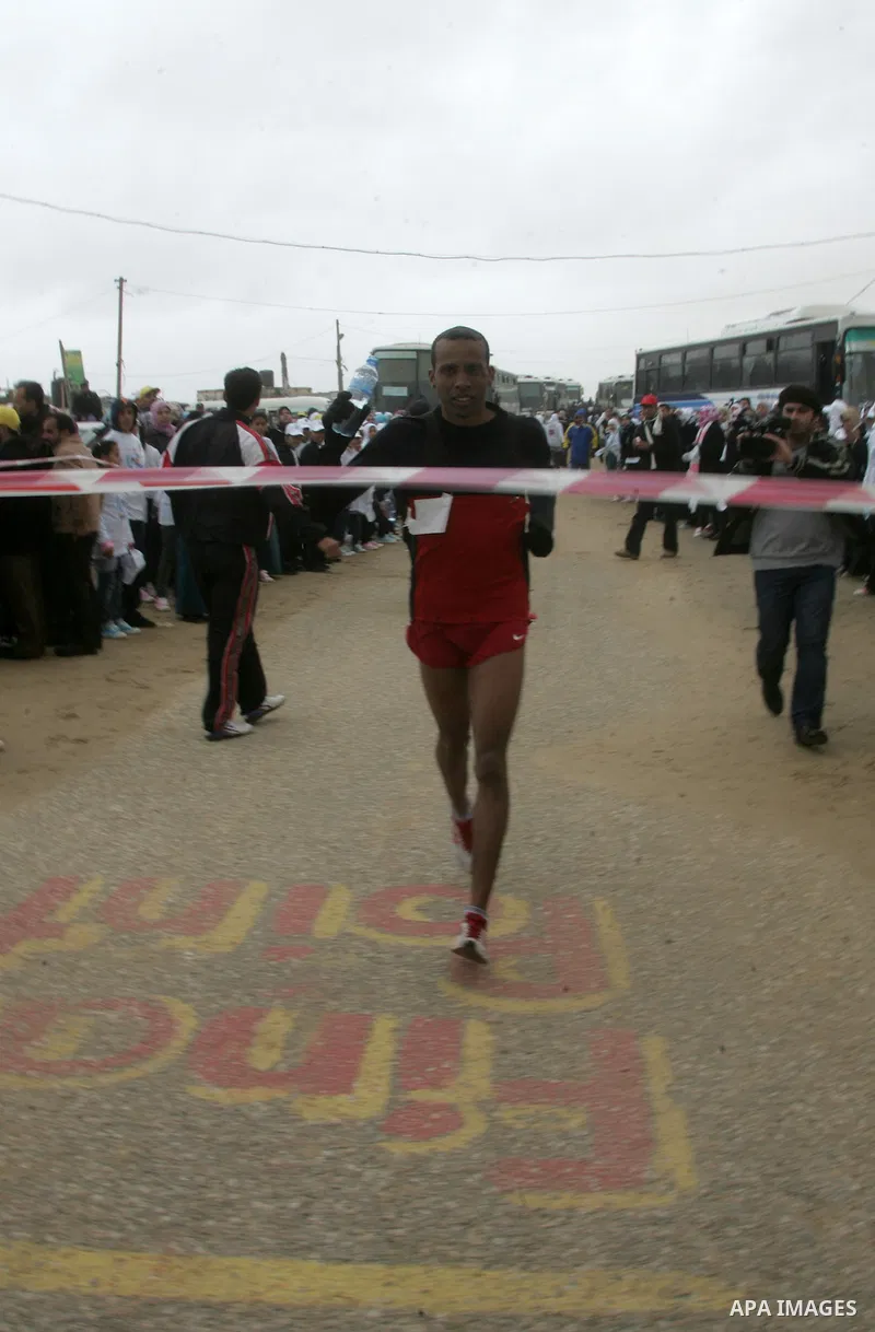 Participants warm up before competing in the UN-sponsored Gaza marathon in Rafah town, in the southern Gaza Strip on March 1, 2012. Thousands of runners braved temperatures hovering just above zero degrees centigrade to...