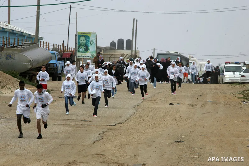 Participants warm up before competing in the UN-sponsored Gaza marathon in Rafah town, in the southern Gaza Strip on March 1, 2012. Thousands of runners braved temperatures hovering just above zero degrees centigrade to...