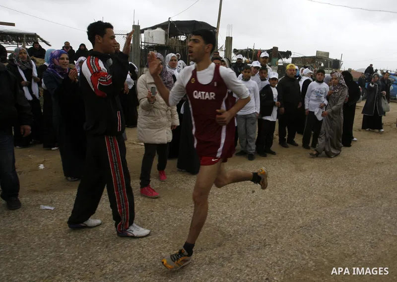 Participants warm up before competing in the UN-sponsored Gaza marathon in Rafah town, in the southern Gaza Strip on March 1, 2012. Thousands of runners braved temperatures hovering just above zero degrees centigrade to...