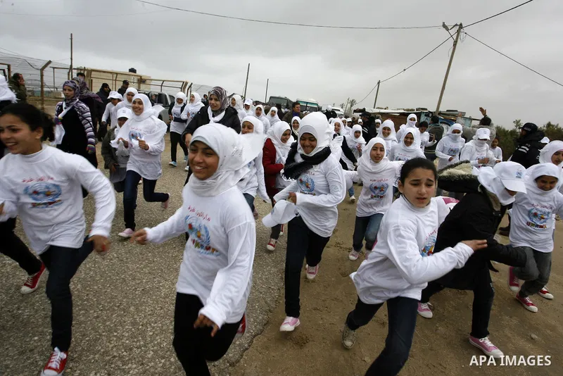 Participants warm up before competing in the UN-sponsored Gaza marathon in Rafah town, in the southern Gaza Strip on March 1, 2012. Thousands of runners braved temperatures hovering just above zero degrees centigrade to...